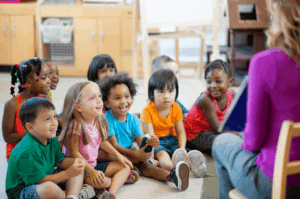 teacher reading aloud to her students