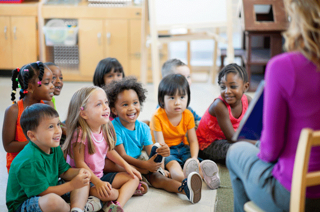 teacher reading aloud to her students